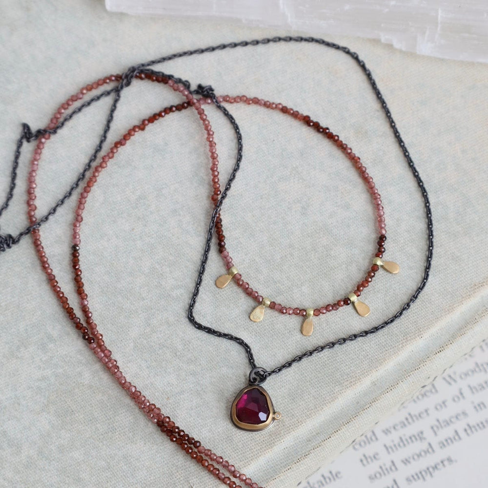 
                      
                        NKL-22K Beaded Ombre Rhonolite Garnet Necklace with 5 22k
                      
                    