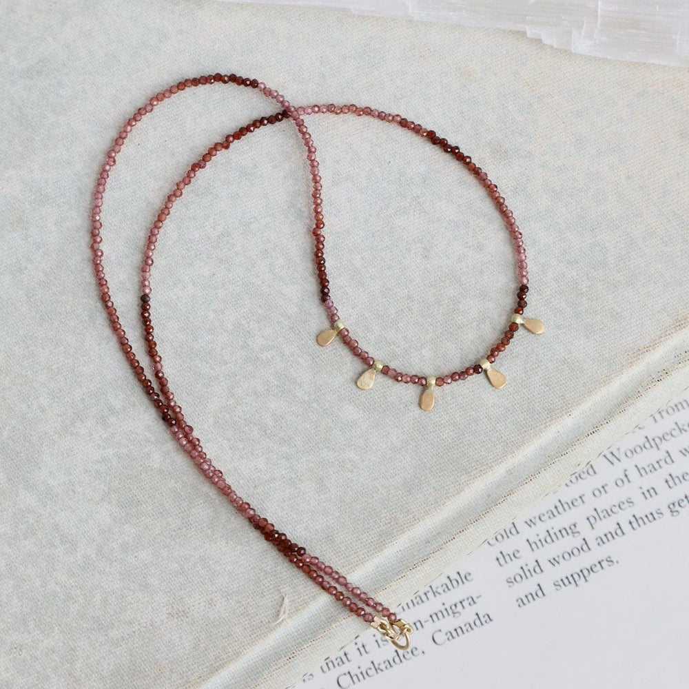 
                      
                        NKL-22K Beaded Ombre Rhonolite Garnet Necklace with 5 22k
                      
                    