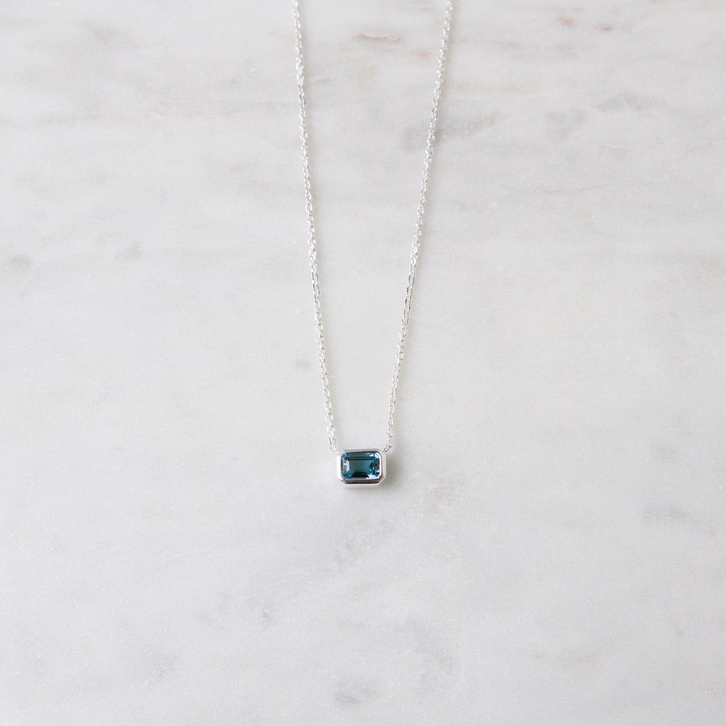 NKL Bezel Set Emerald Cut London Blue Topaz Solitaire Necklace