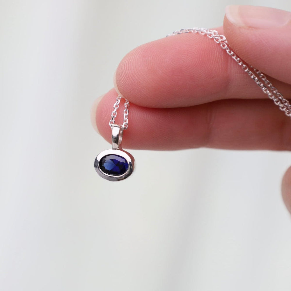 
                      
                        NKL Bezel Set Oval Synthetic Sapphire Pendant Necklace
                      
                    