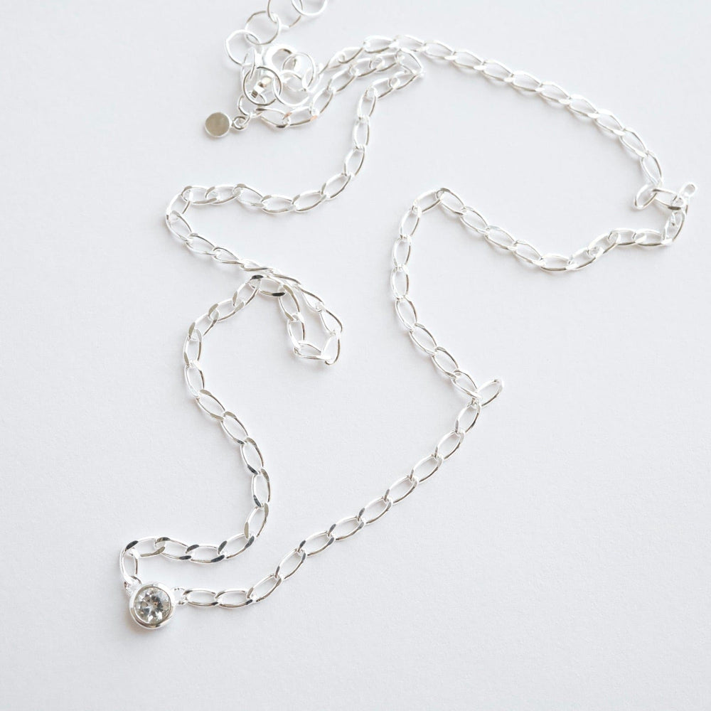 
                  
                    NKL Bezel Set Round White Topaz on Sterling Silver Cut Curb Chain
                  
                