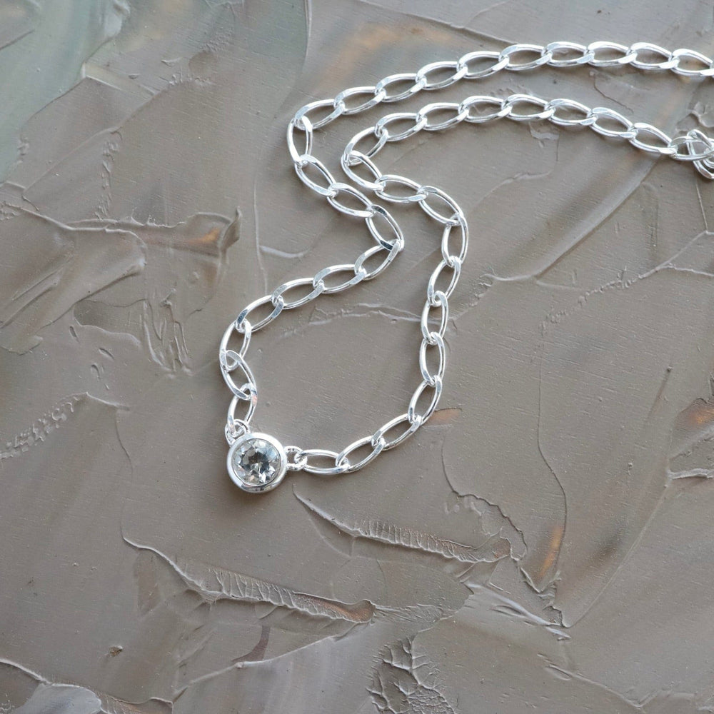 
                  
                    NKL Bezel Set Round White Topaz on Sterling Silver Cut Curb Chain
                  
                