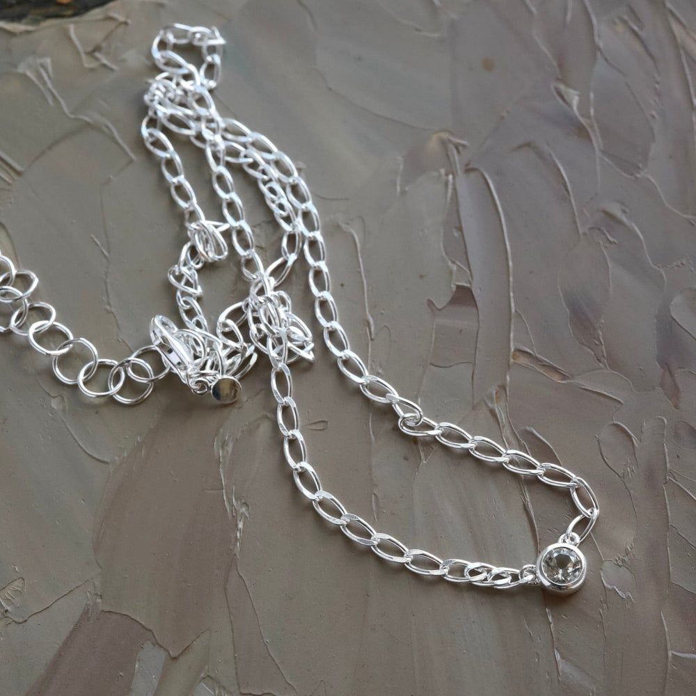 
                  
                    NKL Bezel Set Round White Topaz on Sterling Silver Cut Curb Chain
                  
                