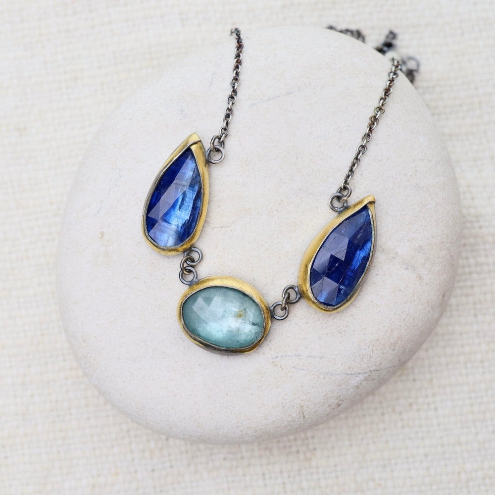 
                      
                        NKL Bright Blue Kyanite 3 Stone Teardrop & Oval Crescent Rim Necklace
                      
                    