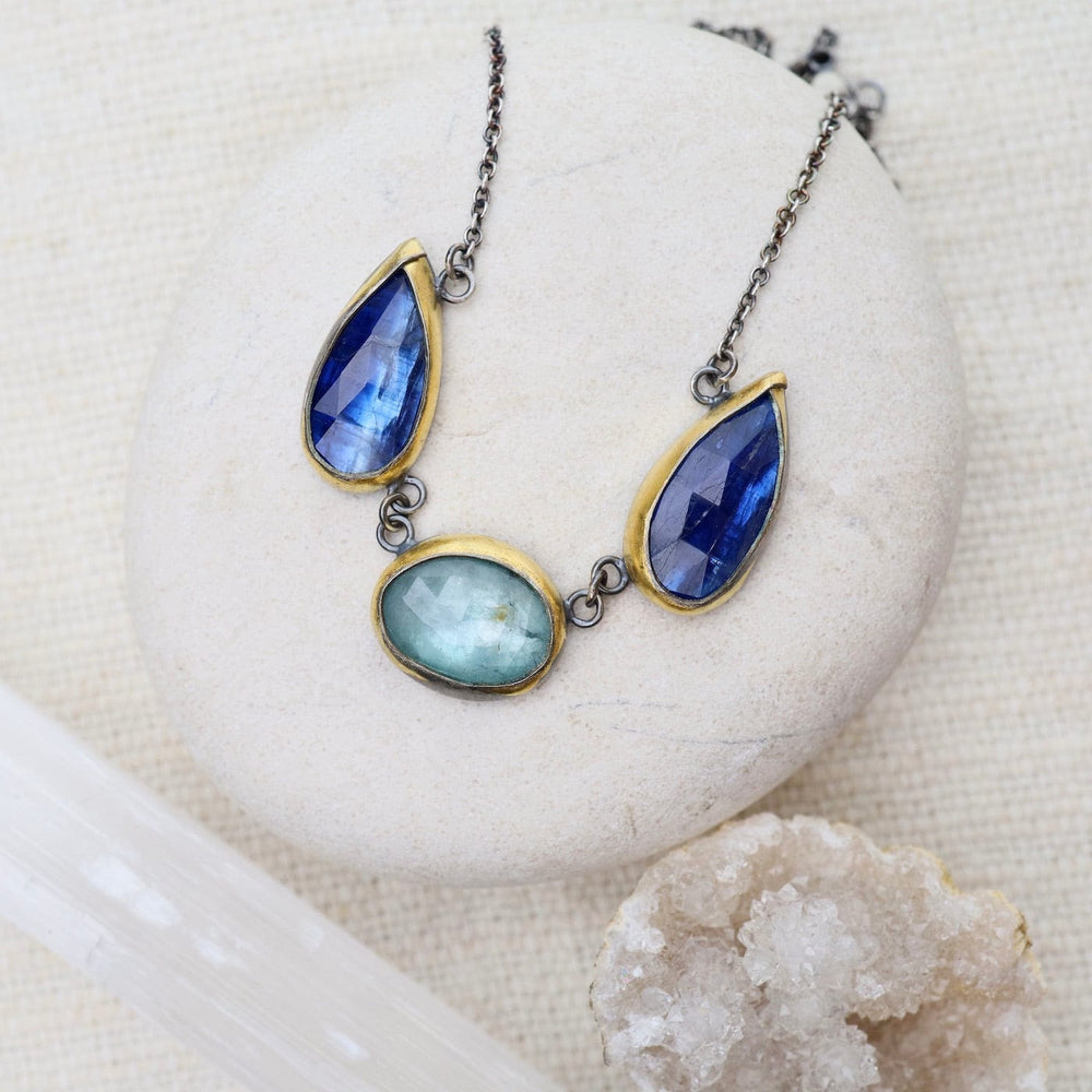 
                      
                        NKL Bright Blue Kyanite 3 Stone Teardrop & Oval Crescent Rim Necklace
                      
                    