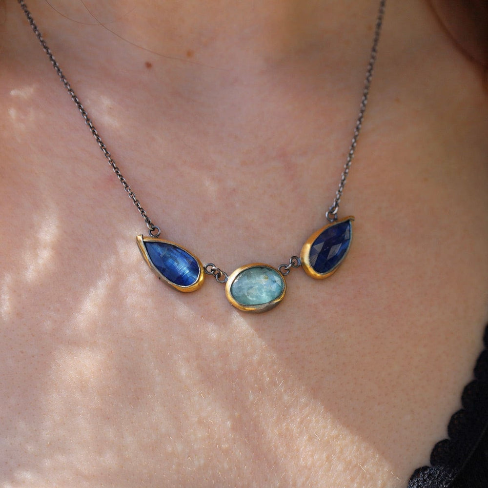 
                      
                        NKL Bright Blue Kyanite 3 Stone Teardrop & Oval Crescent Rim Necklace
                      
                    