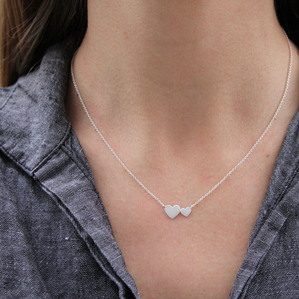 
                      
                        NKL Brushed Sterling Silver Big & Little Hearts Necklace
                      
                    