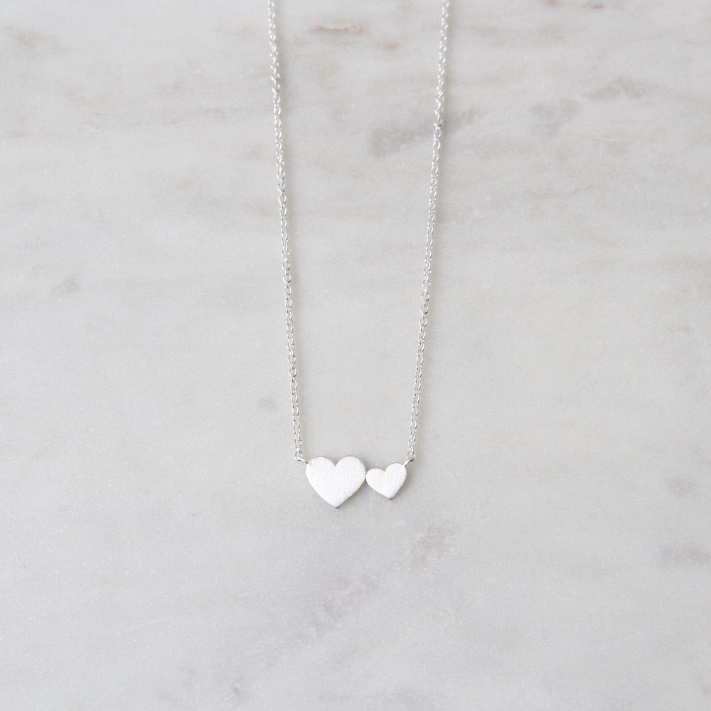 
                      
                        NKL Brushed Sterling Silver Big & Little Hearts Necklace
                      
                    