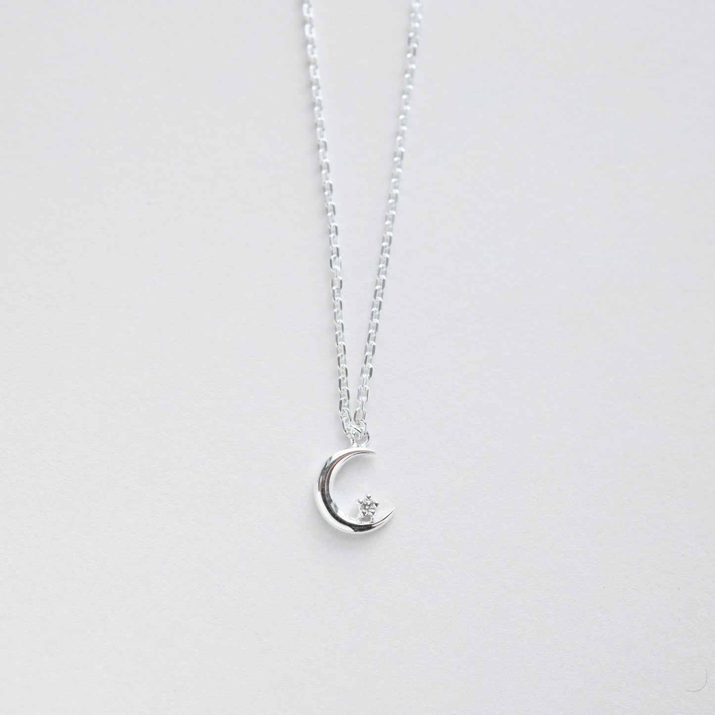 NKL Crescent Moon with Single CZ in Sterling Silver