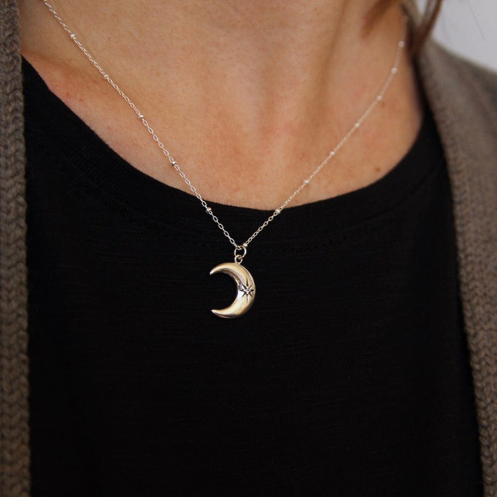 
                      
                        NKL Crescent Moon with Star Set White Sapphire
                      
                    