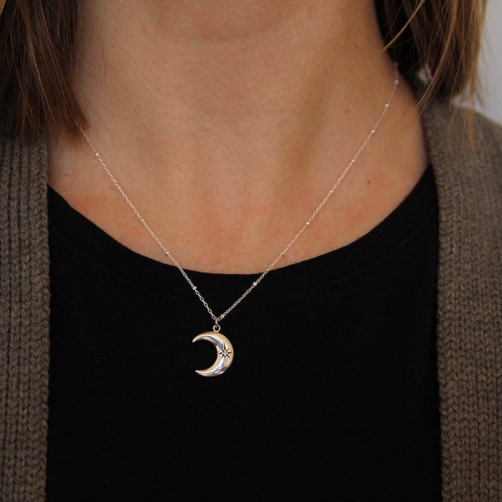 
                      
                        NKL Crescent Moon with Star Set White Sapphire
                      
                    