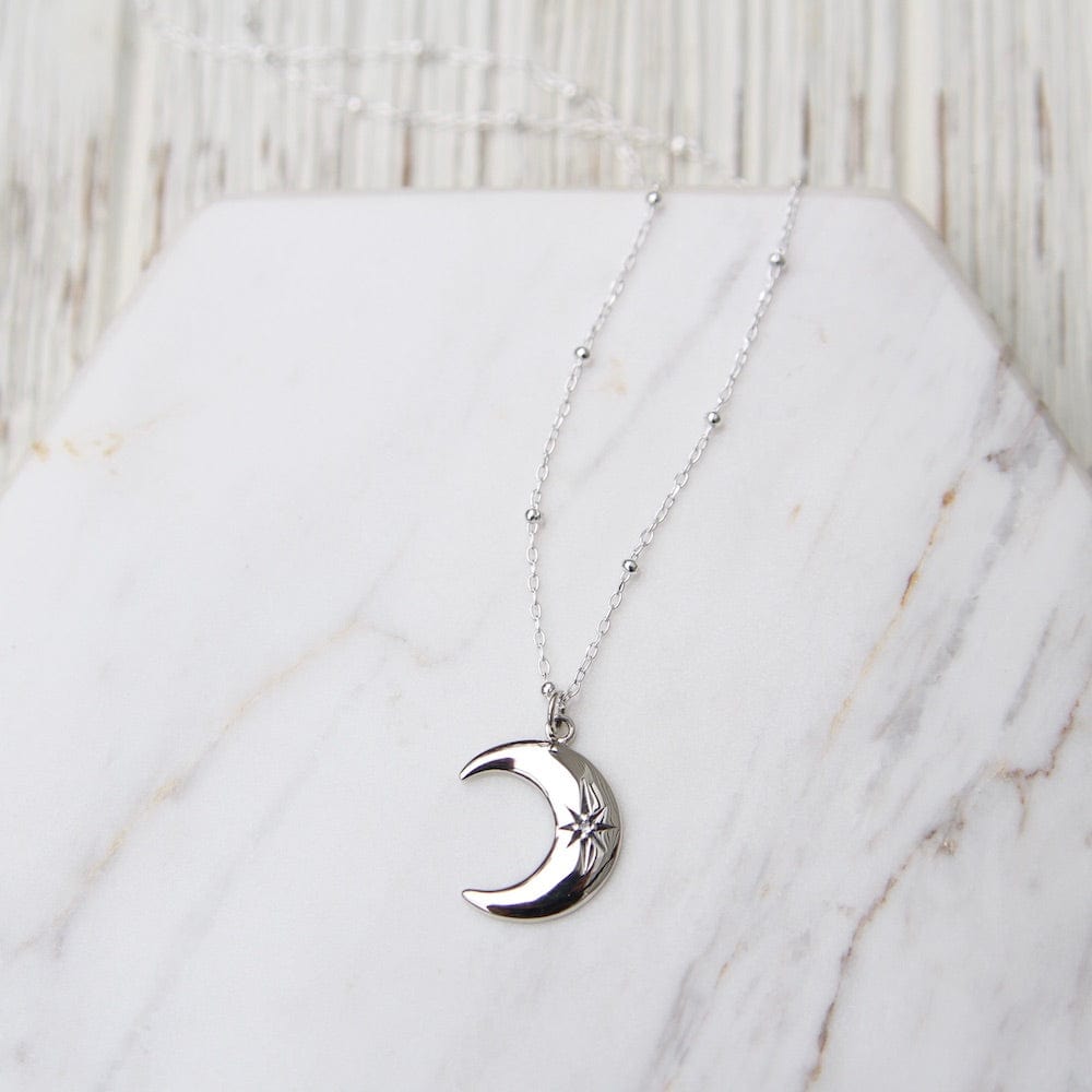 
                      
                        NKL Crescent Moon with Star Set White Sapphire
                      
                    