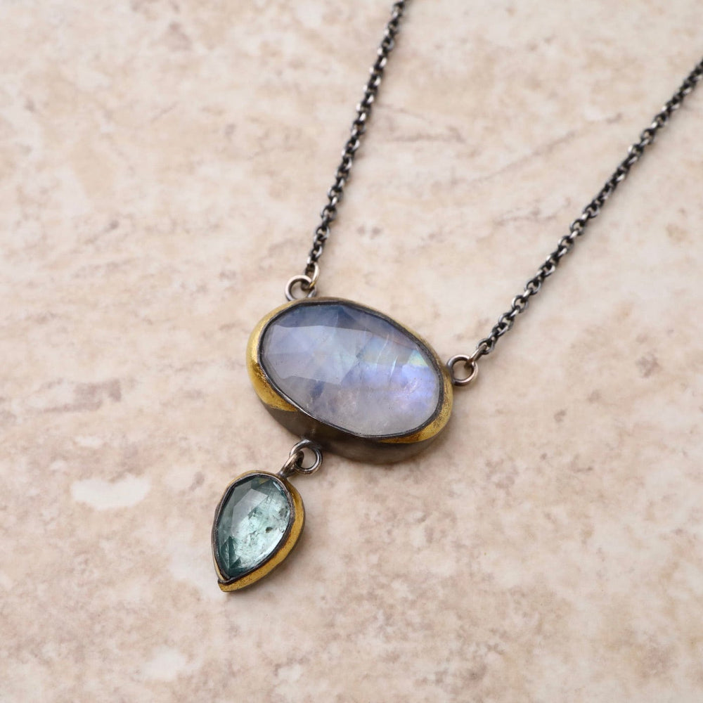 
                      
                        NKL Crescent Rim Drop Necklace with Moonstone & Sky Blue Kyanite
                      
                    