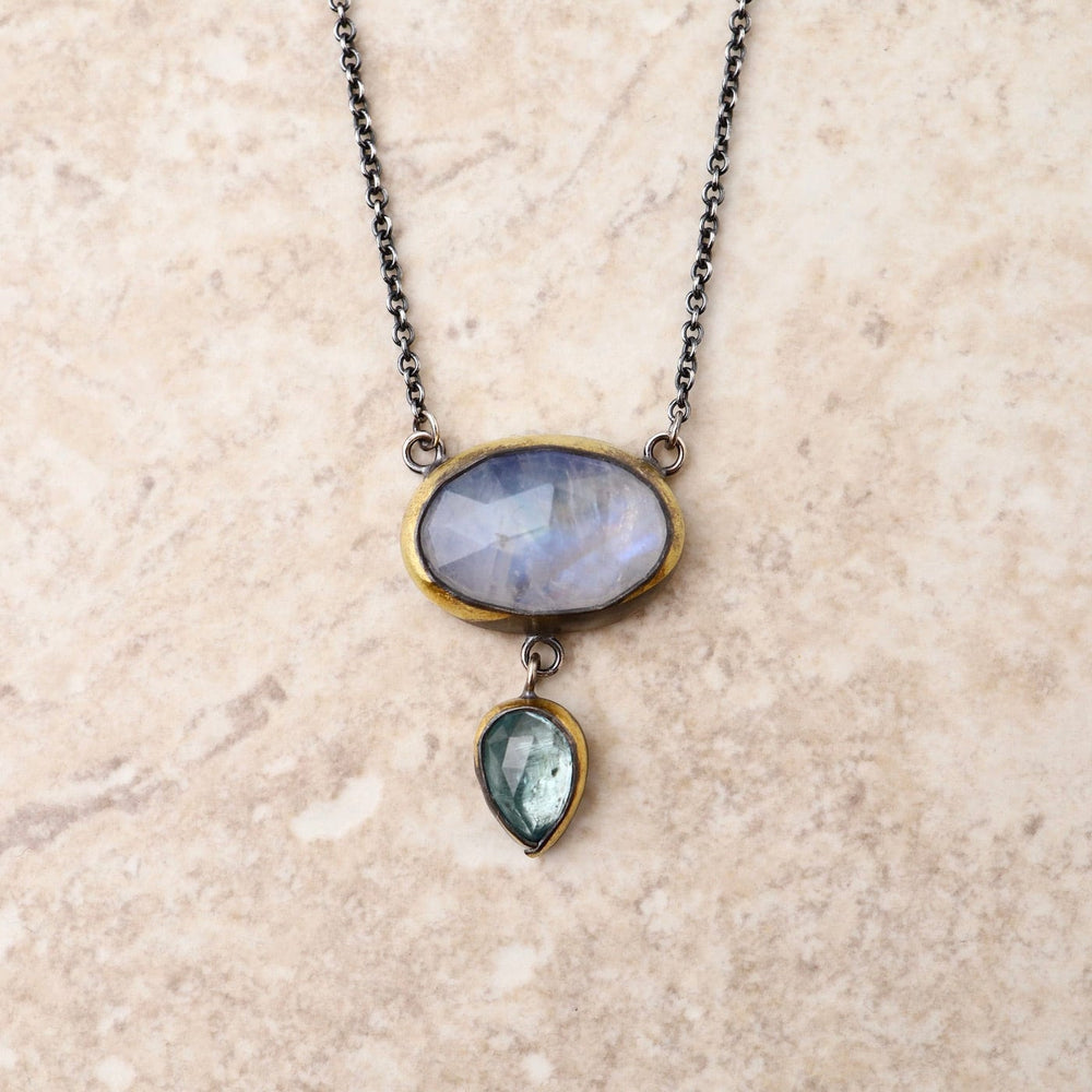 
                      
                        NKL Crescent Rim Drop Necklace with Moonstone & Sky Blue Kyanite
                      
                    