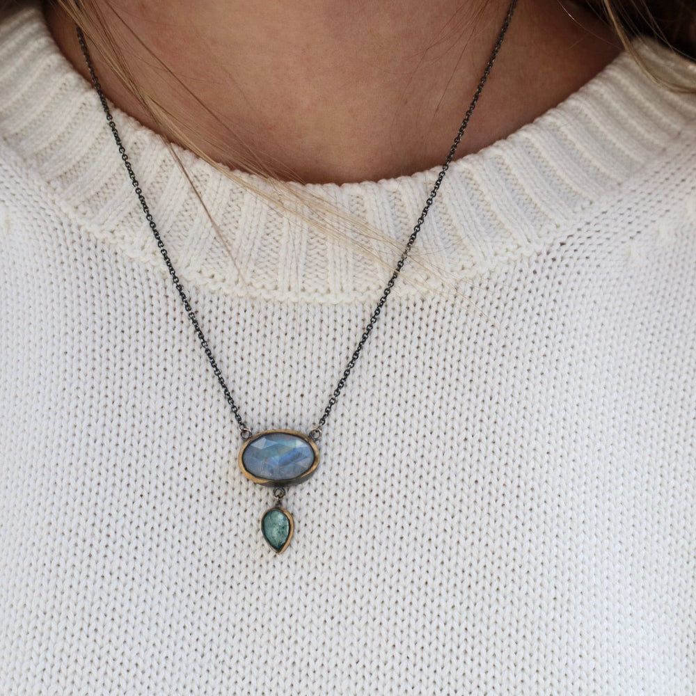 
                      
                        NKL Crescent Rim Drop Necklace with Moonstone & Sky Blue Kyanite
                      
                    