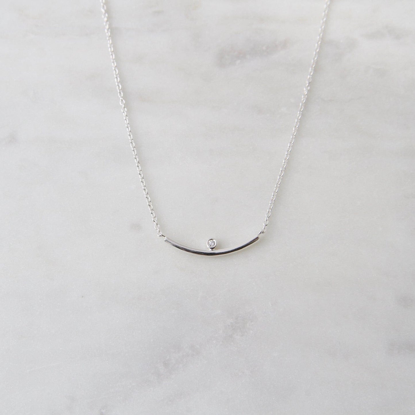 NKL Curved bar necklace with bezel set CZ