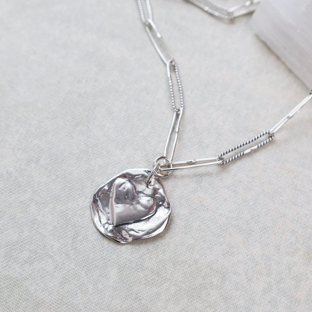 
                      
                        NKL Double Sided Heart and Star Charm on Handmade Oval
                      
                    