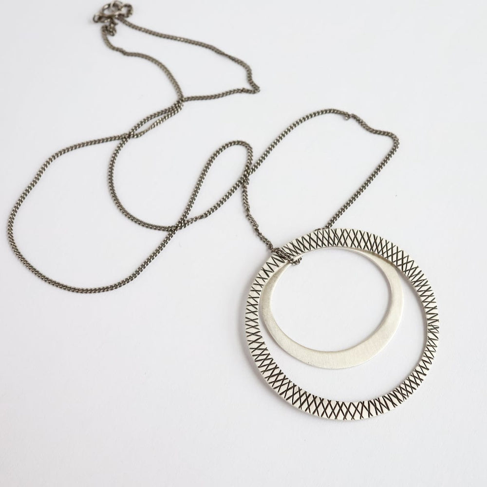 
                      
                        NKL Etched & Plain Silver Circles Necklace
                      
                    