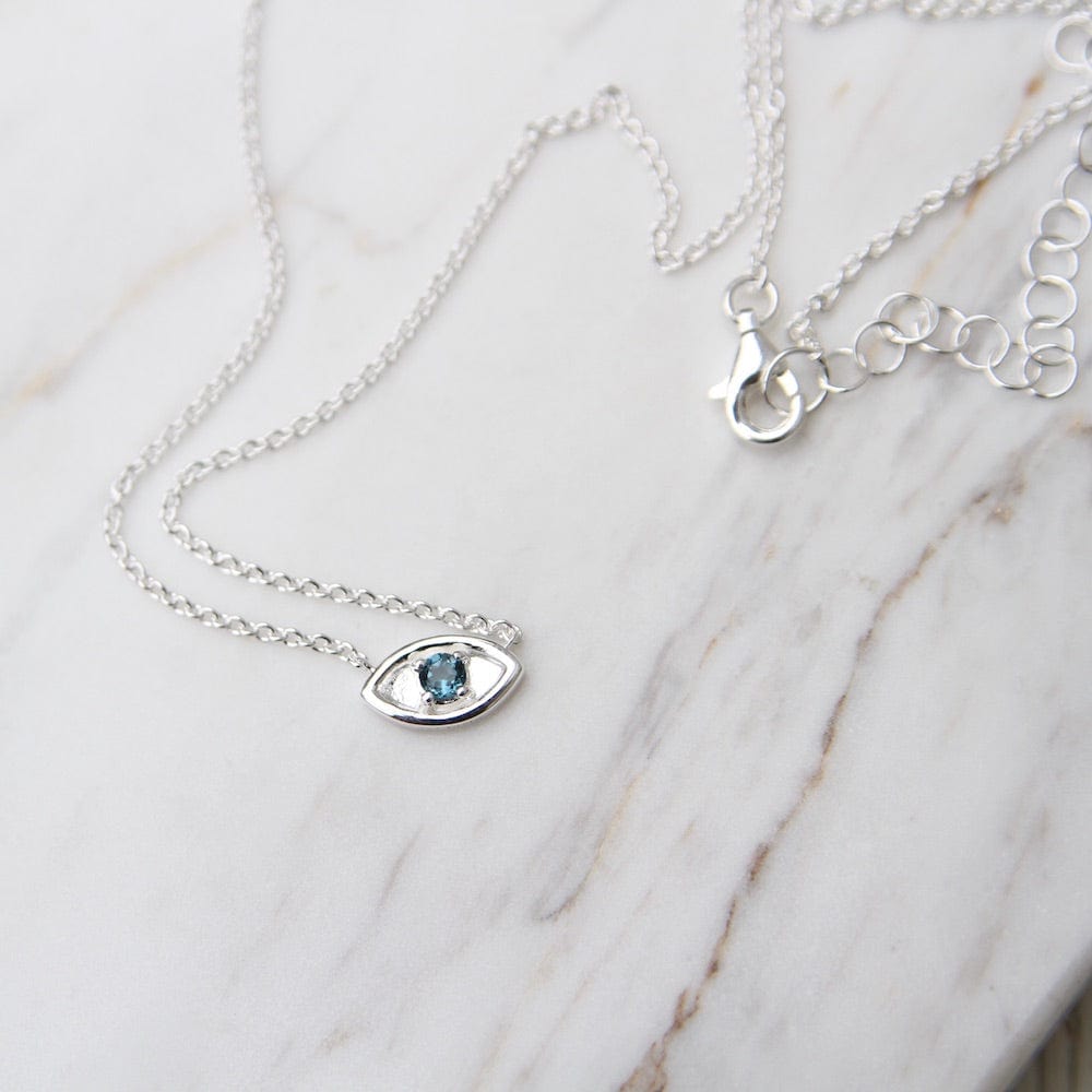 
                      
                        NKL Evil Eye with London Blue Topaz - Sterling Silver
                      
                    