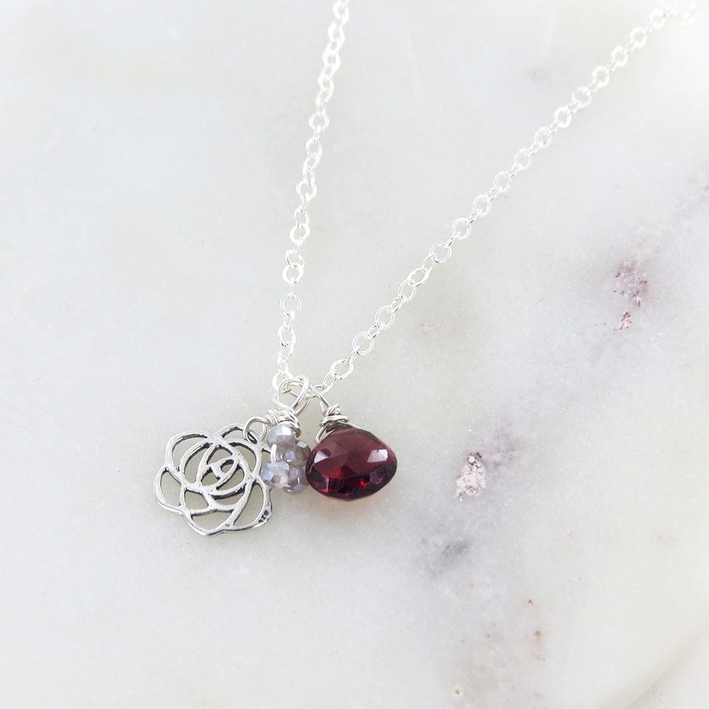 
                      
                        NKL FLOWER AND GARNET NECKLACE
                      
                    