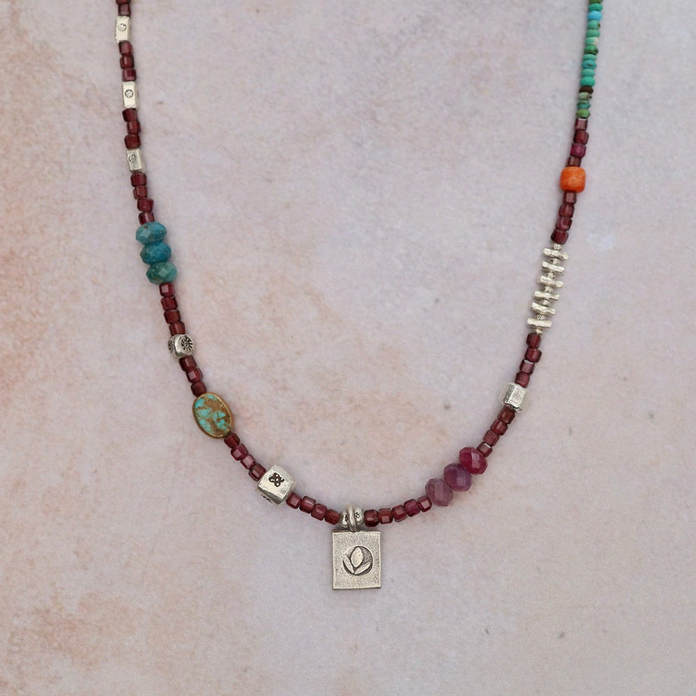 
                      
                        NKL Garnet Cube with Lotus Necklace
                      
                    