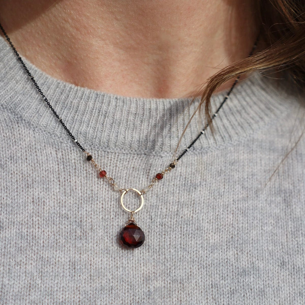 
                  
                    NKL-GF Gold Filled Ring With Garnet Drop On Sterling Gunmetal Necklace
                  
                