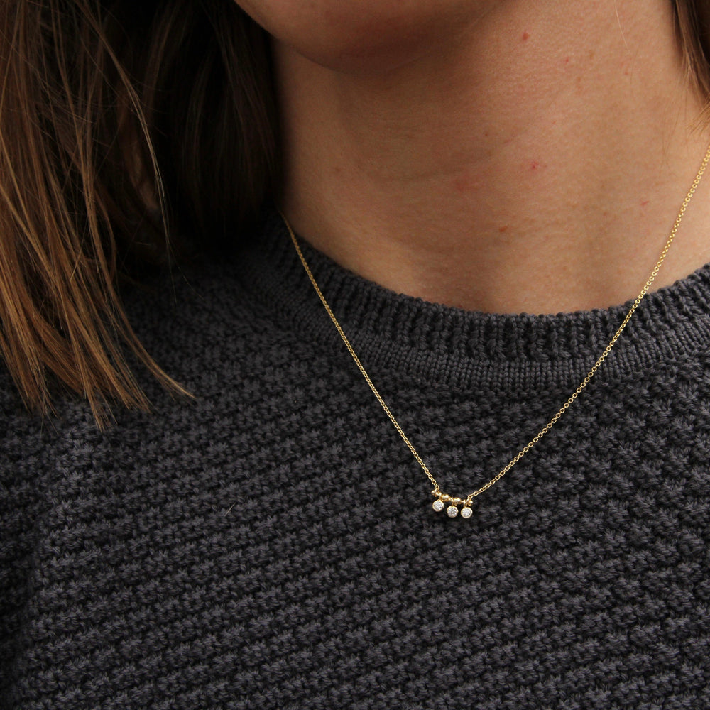 
                      
                        NKL-GPL Gold Shimmer Triple Stud Necklace
                      
                    