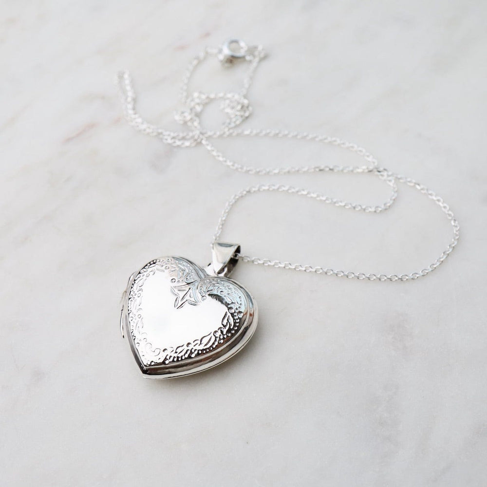 
                  
                    NKL Heart Locket Necklace with Edge Details
                  
                