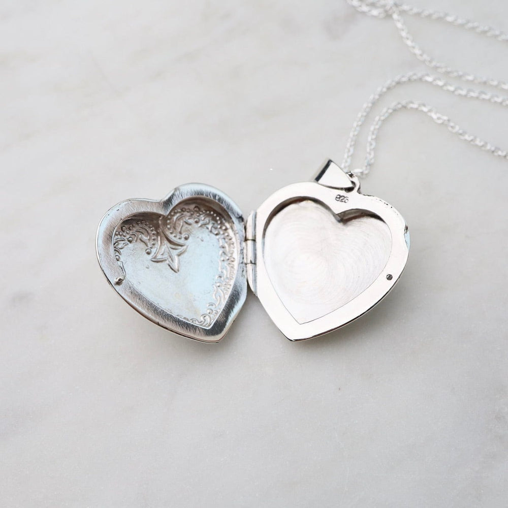 
                  
                    NKL Heart Locket Necklace with Edge Details
                  
                