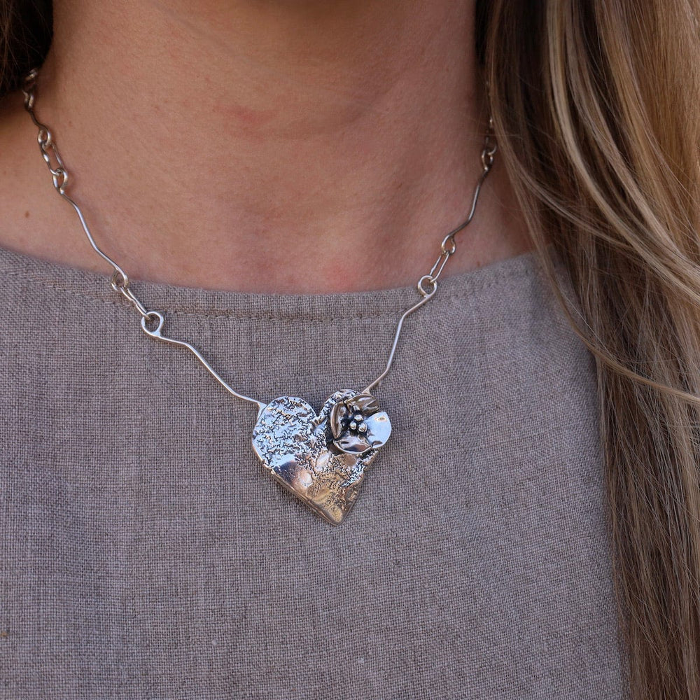 
                      
                        NKL Heart with Dogwood Flower Necklace
                      
                    