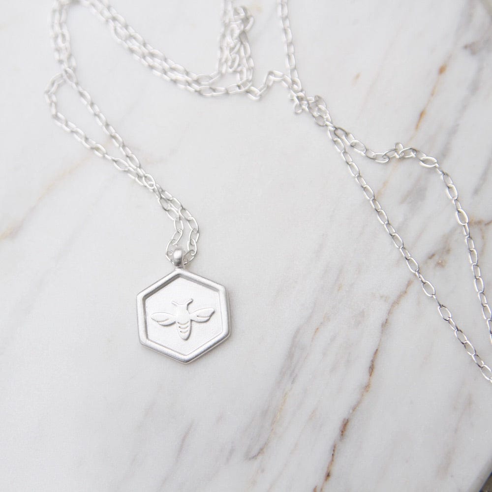 
                      
                        NKL Hex with Bee Necklace - Brushed Sterling Silver
                      
                    