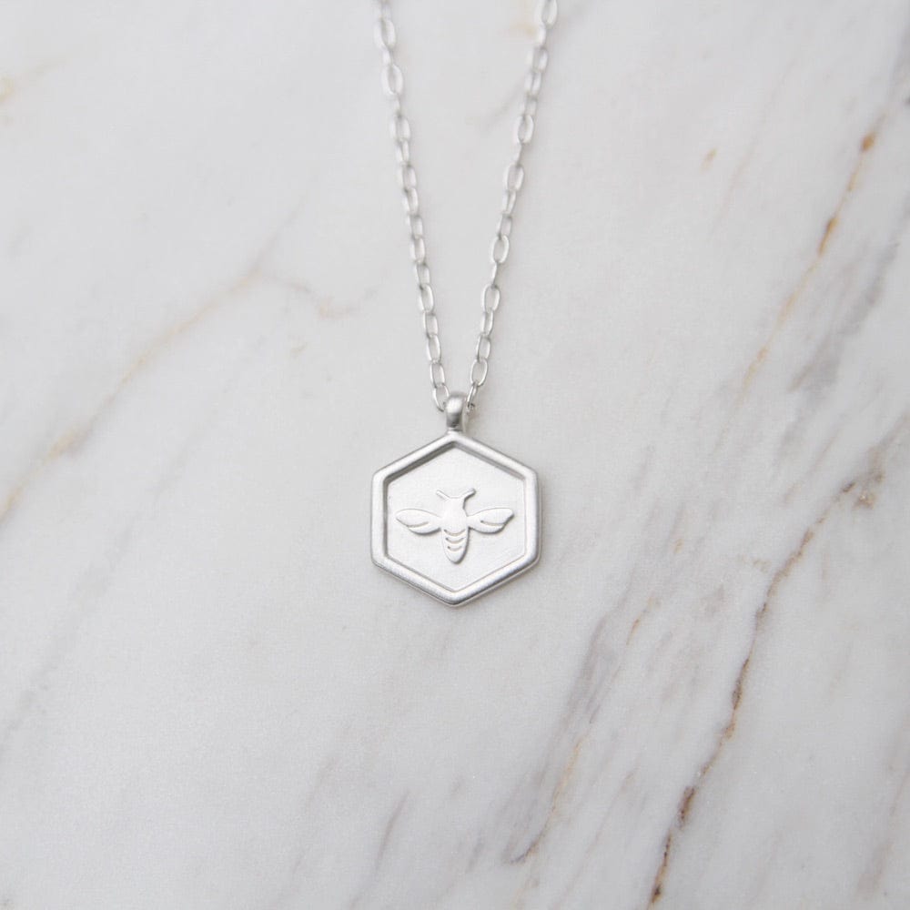 
                      
                        NKL Hex with Bee Necklace - Brushed Sterling Silver
                      
                    