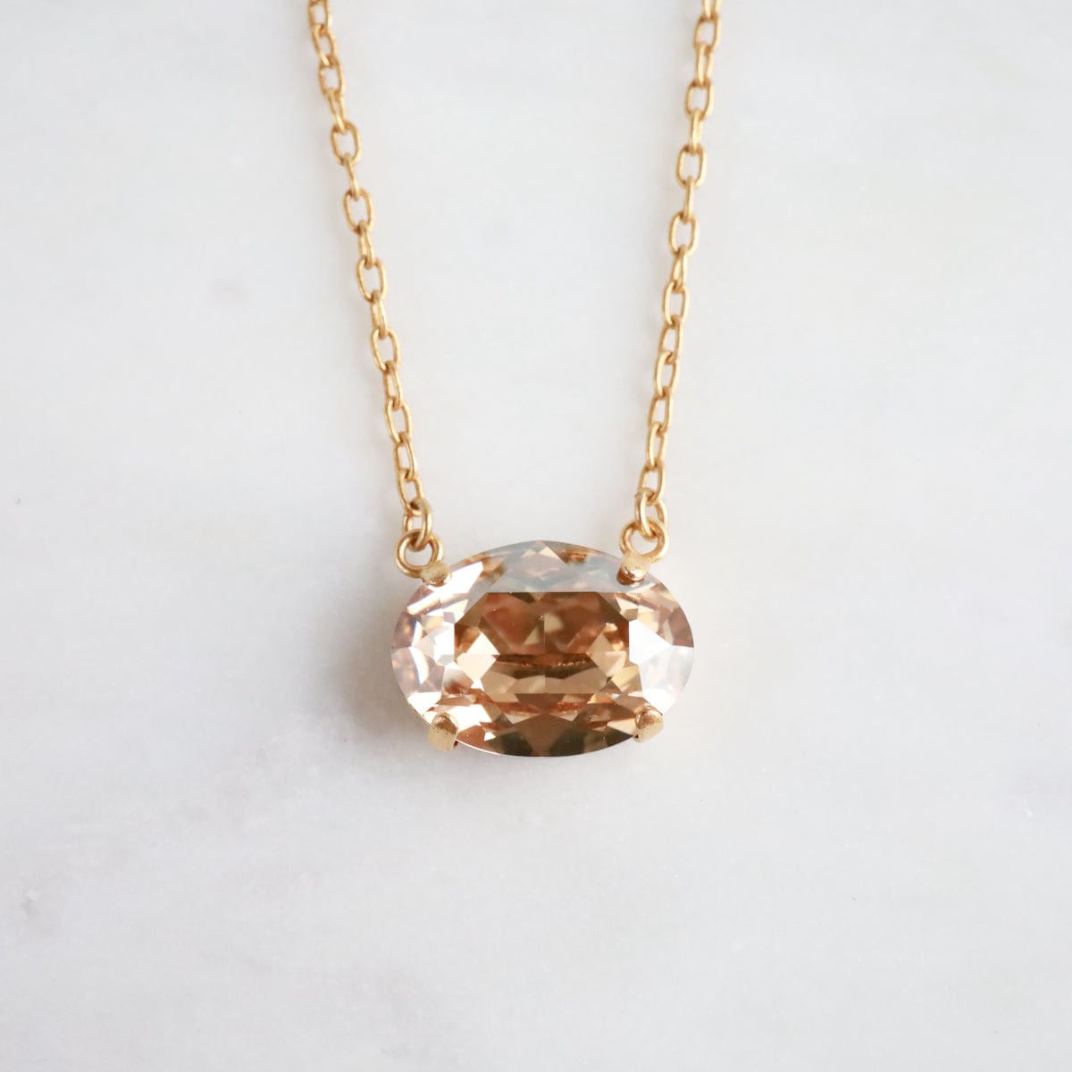 NKL-JM Gold Oval Crystal Pendant - Champagne