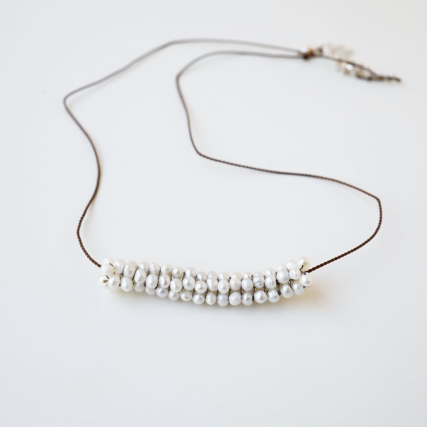 NKL-JM Hand Stitched Tiny White Pearls with Silver Trim Necklace