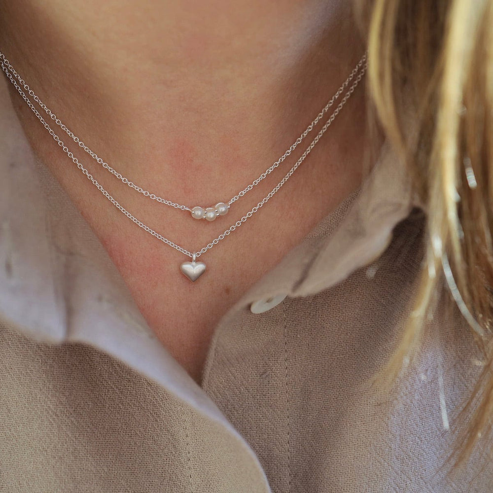 
                      
                        NKL Little Curve Necklace with Three White Freshwater Pearls
                      
                    