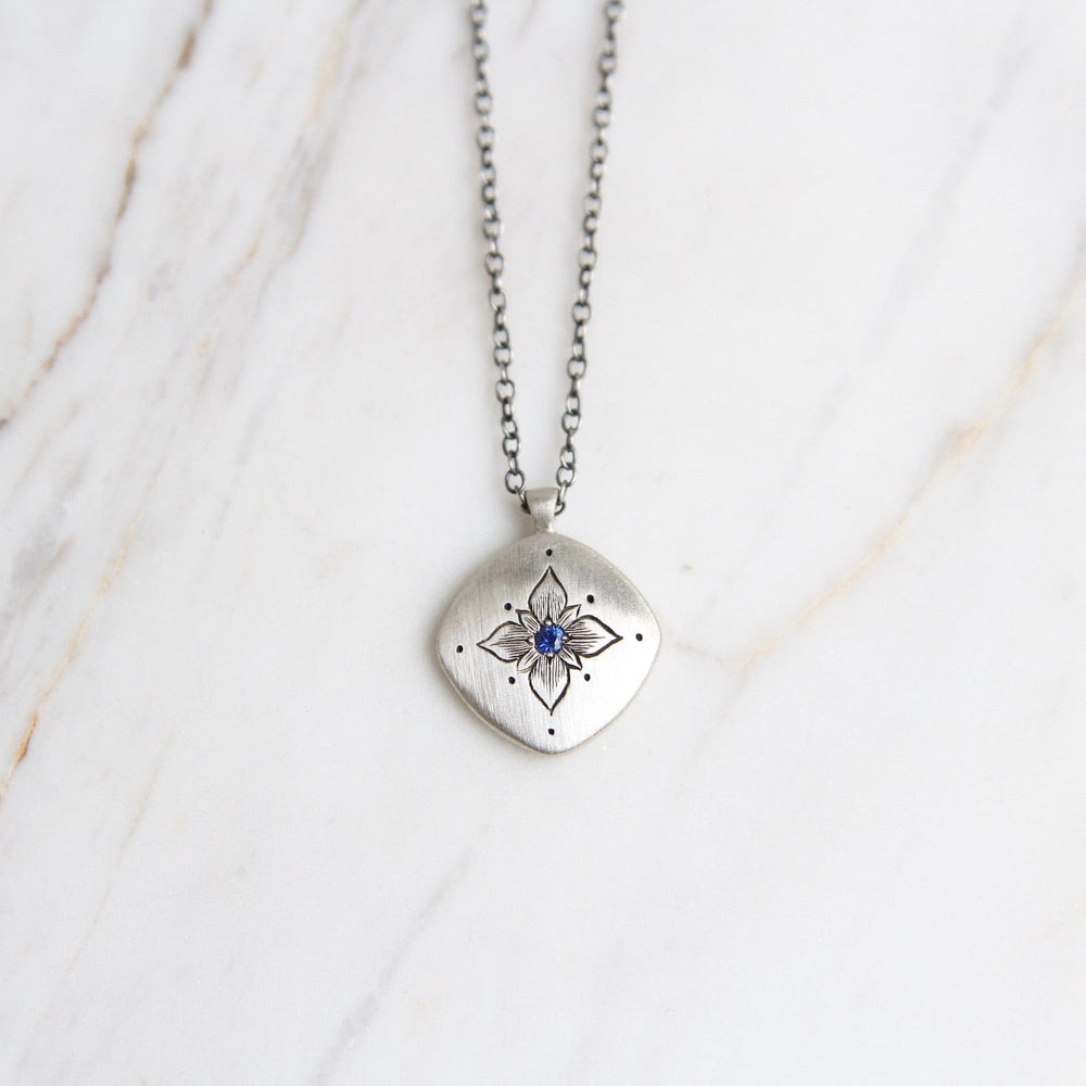 
                      
                        NKL Lotus Cushion Pendant in Sapphire
                      
                    