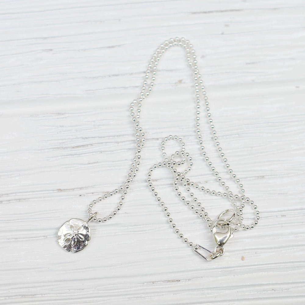 
                      
                        NKL Mini Sand Dollar Necklace in Sterling Silver
                      
                    