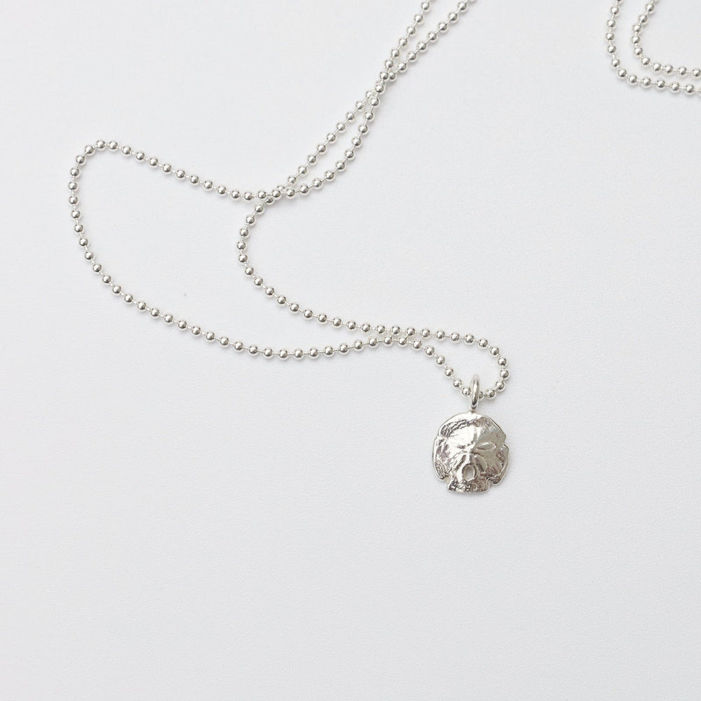 
                      
                        NKL Mini Sand Dollar Necklace in Sterling Silver
                      
                    