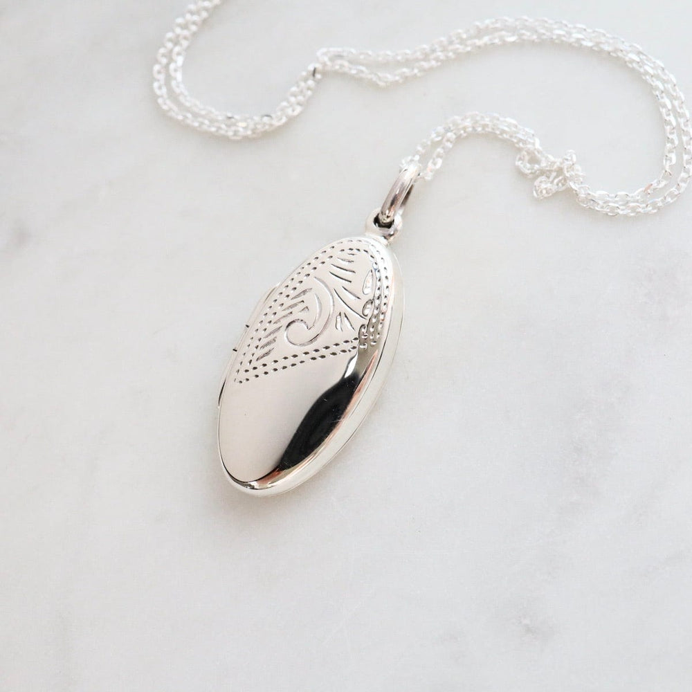 
                  
                    NKL Oval Locket Necklace with Etched Pattern
                  
                