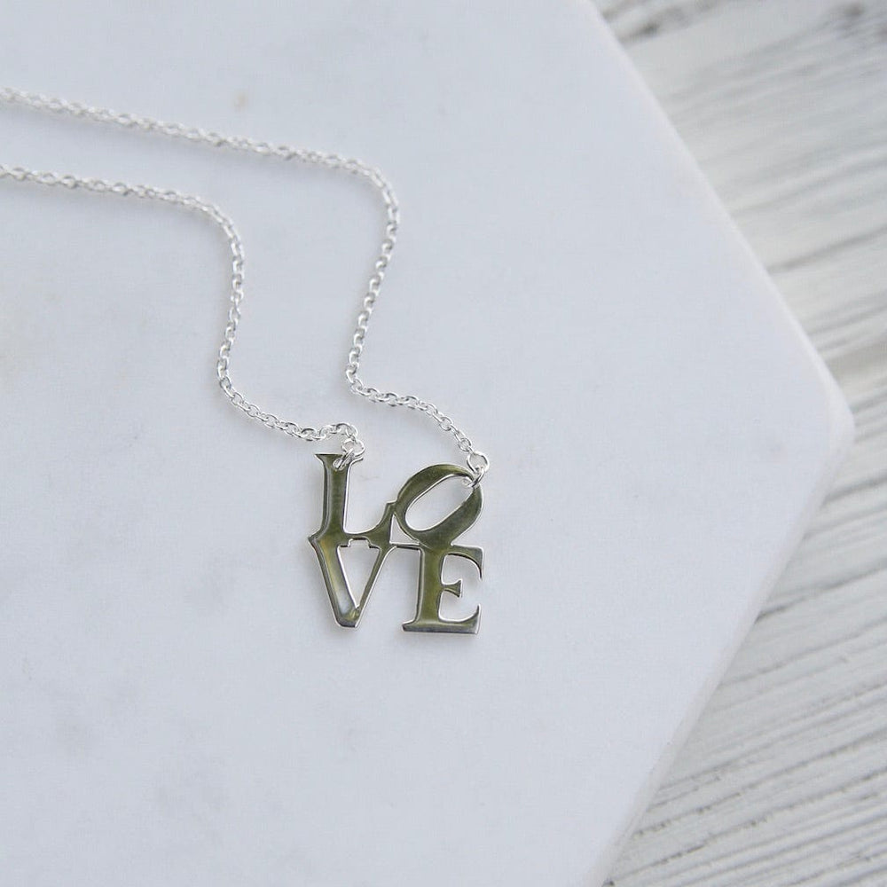 
                      
                        NKL Polished Silver LOVE Sculpture Necklace
                      
                    