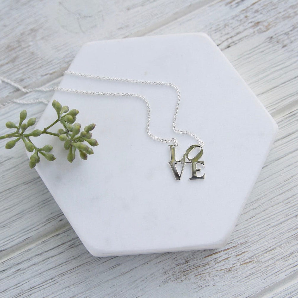 
                      
                        NKL Polished Silver LOVE Sculpture Necklace
                      
                    