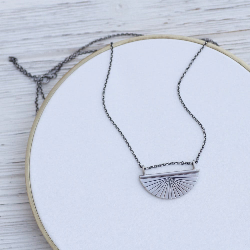 
                      
                        NKL Radiant Half Disc Amulet Necklace
                      
                    