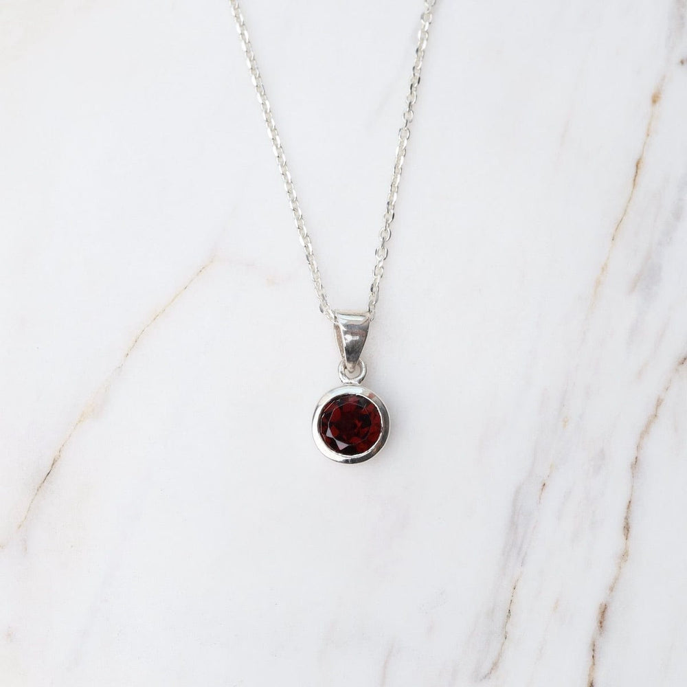 
                      
                        NKL Round African Garnet Pendant
                      
                    