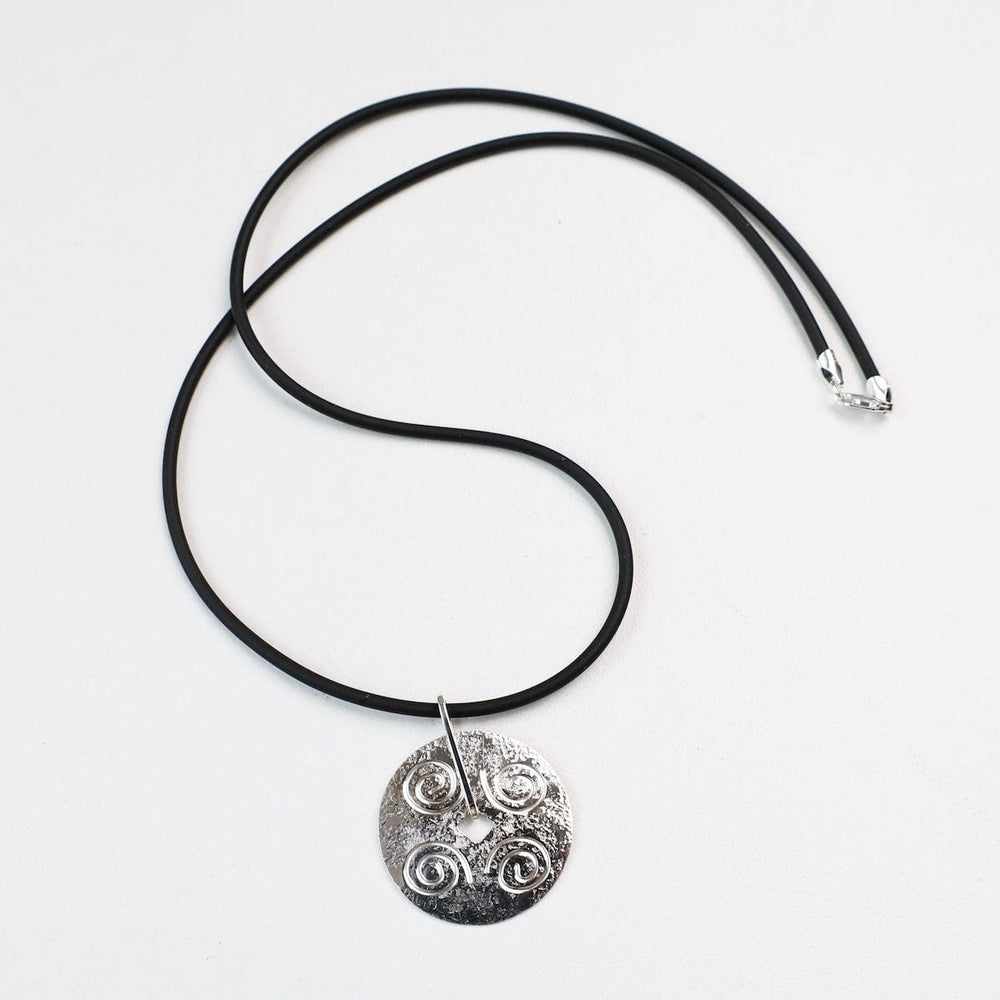 
                  
                    NKL Round Disc Pendant with Swirls on Black Cord
                  
                