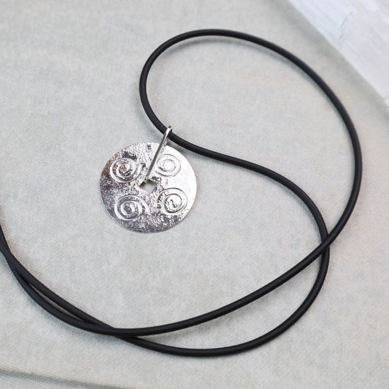 NKL Round Disc Pendant with Swirls on Black Cord