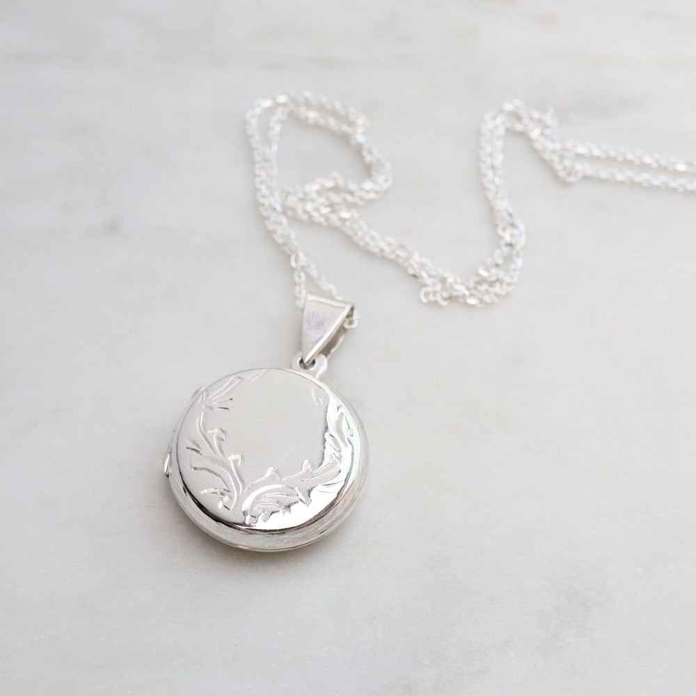 
                  
                    NKL Round Locket Necklace with Vine Details
                  
                