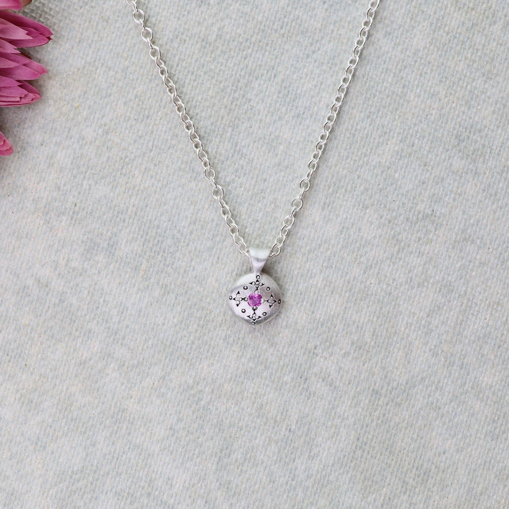 
                      
                        NKL Silver Lights Charm Pendant in Pink Sapphire
                      
                    