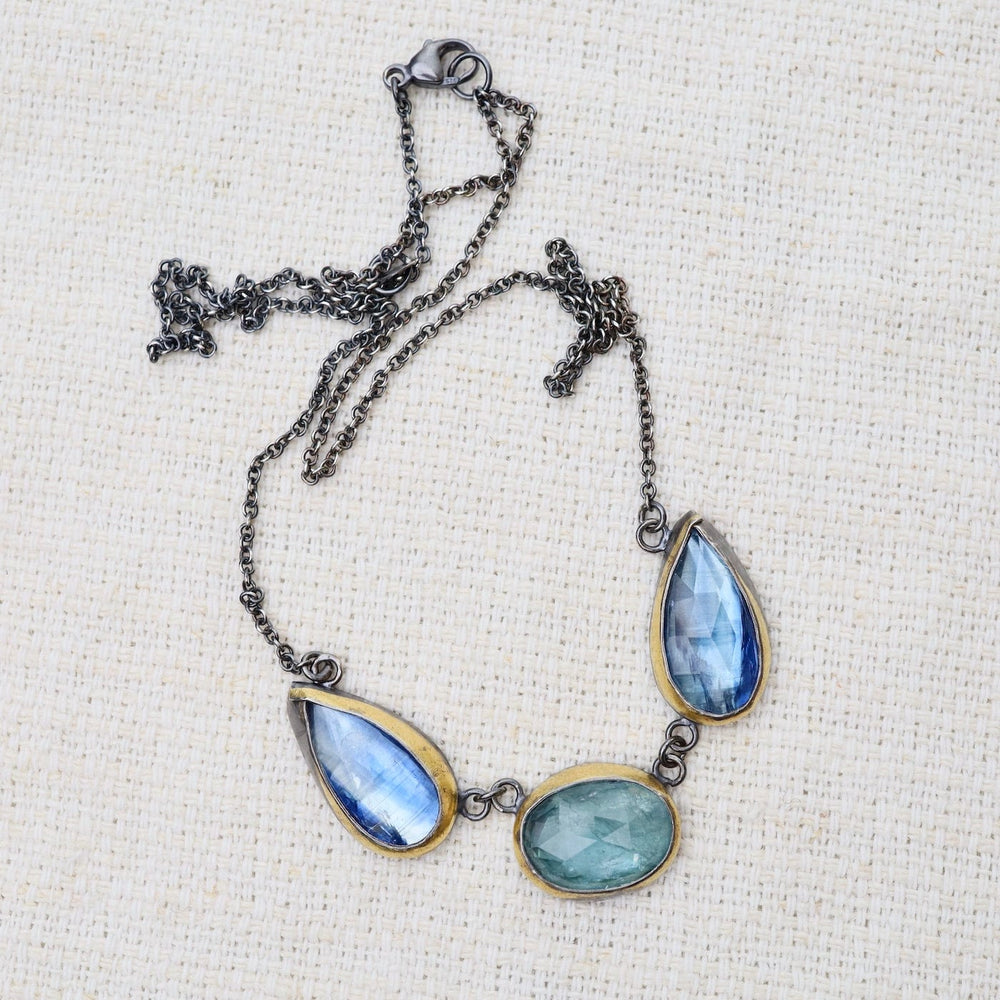 
                      
                        NKL Sky Blue Kyanite 3 Stone Teardrop & Oval Crescent Rim Necklace
                      
                    