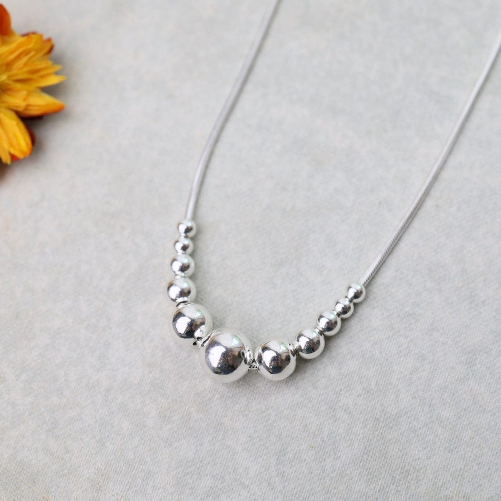 
                  
                    NKL Snake Chain with 11 Graduated Sterling Silver Balls Necklace
                  
                