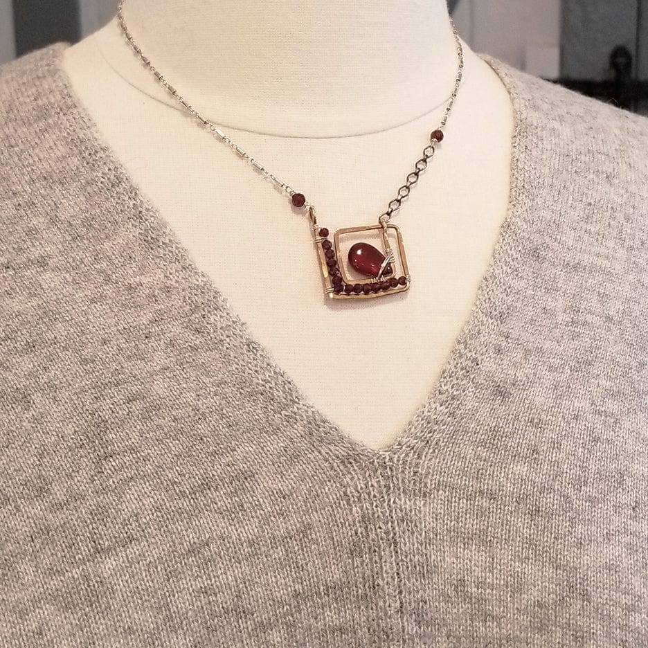 NKL SQUARE SPIRAL WITH CARNELIAN DROP AND FACETED GARNETS NECKLACE
